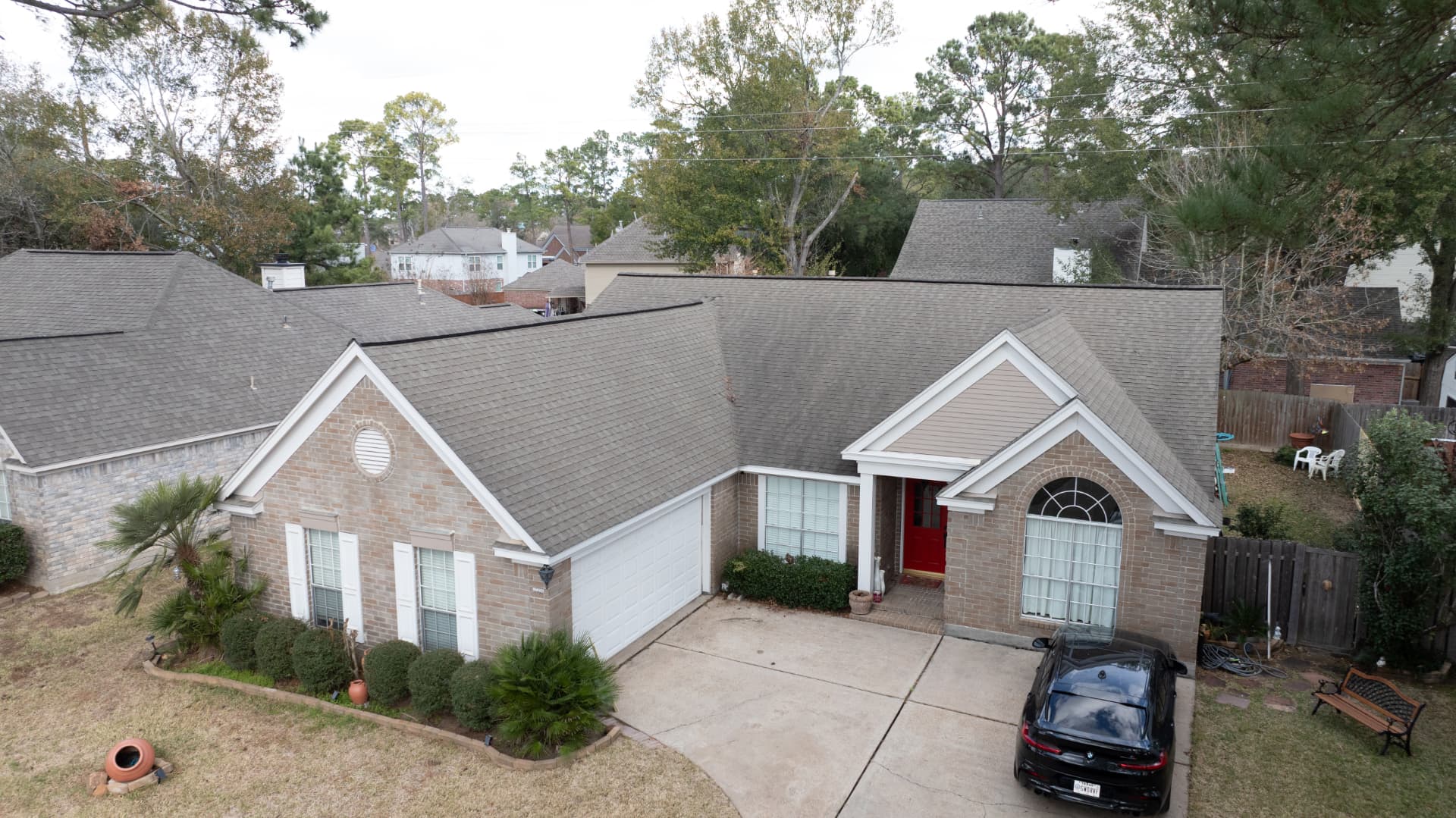 Front aerial view of a completed asphalt shingle roof replacement in Houston