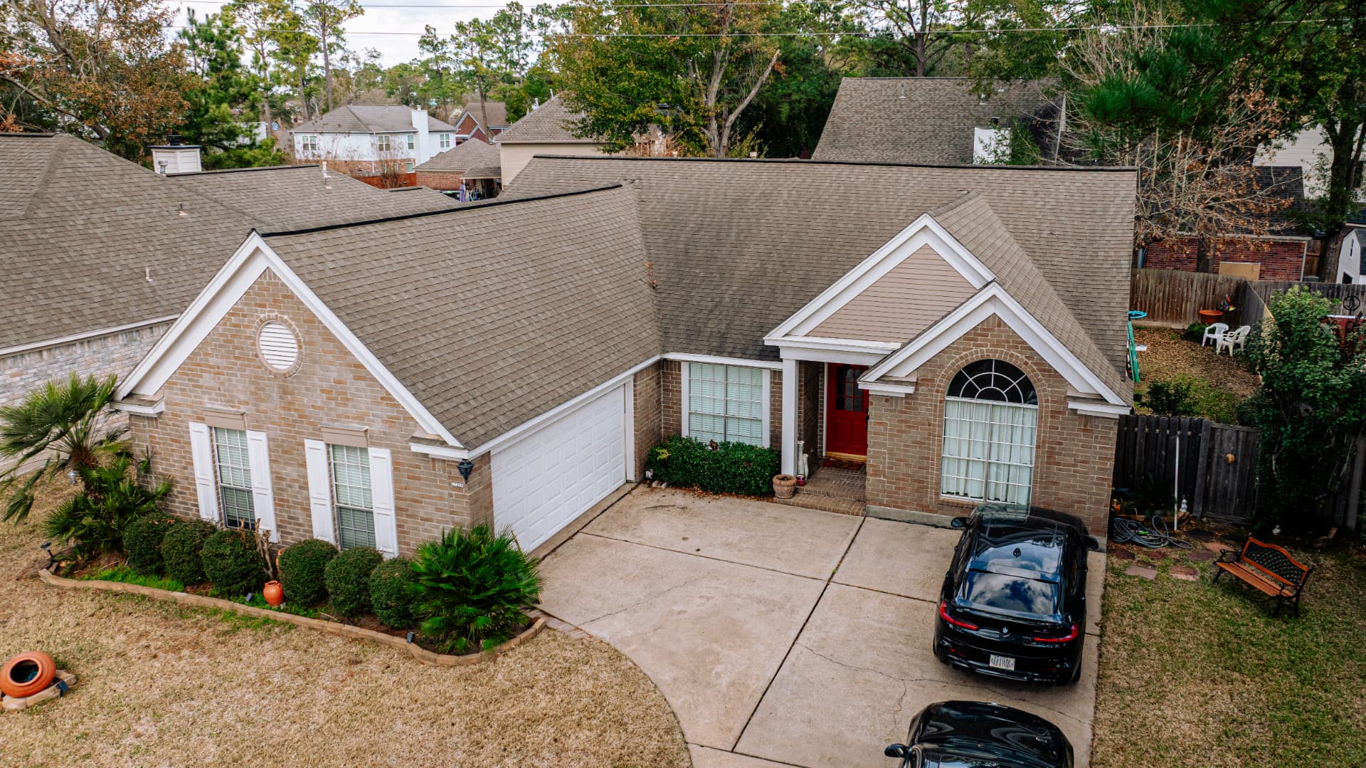 Front aerial view of a completed asphalt shingle roof replacement in Houston