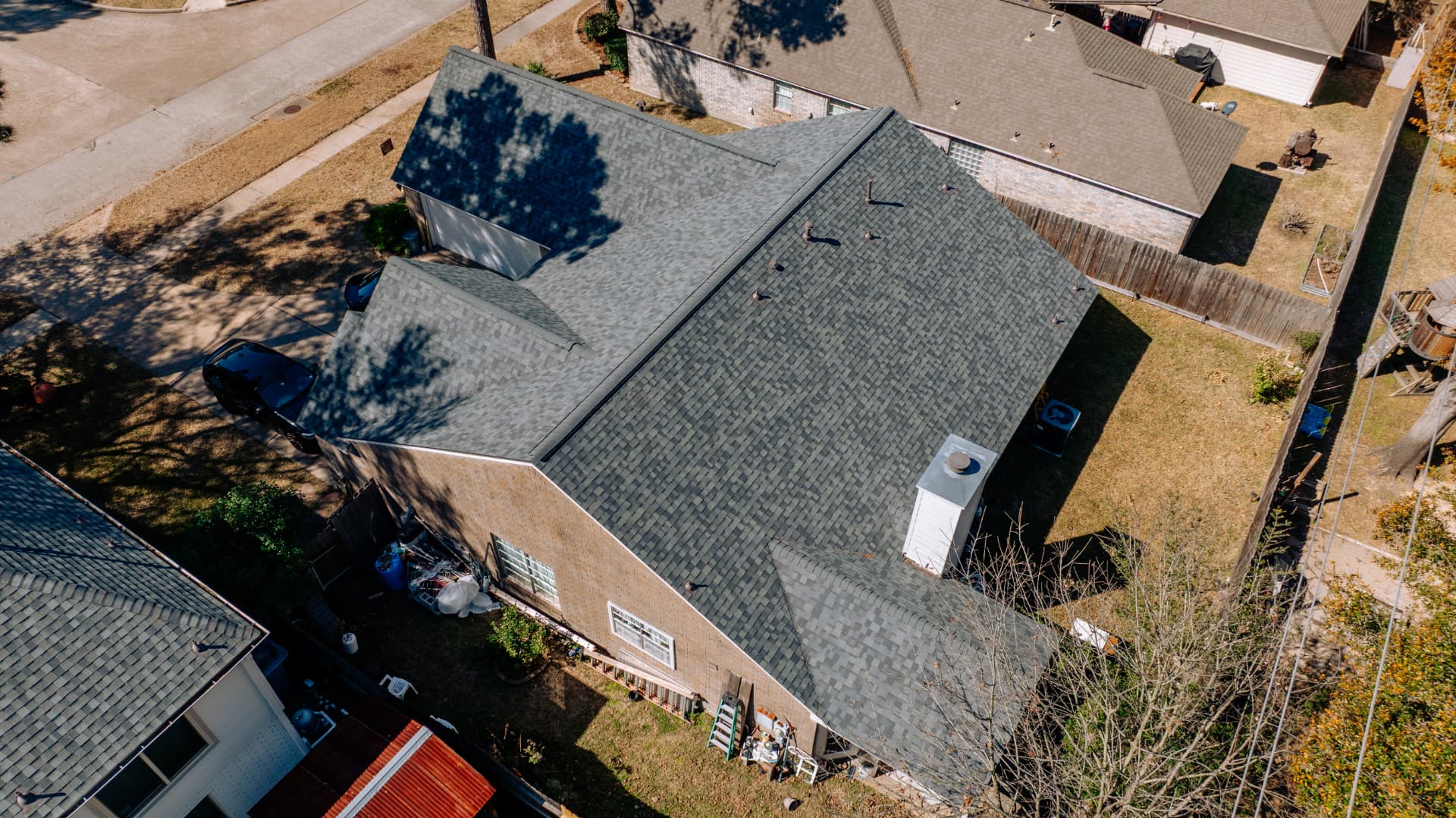 Close aerial view of an aging asphalt shingle roof evaluated for replacement in Houston