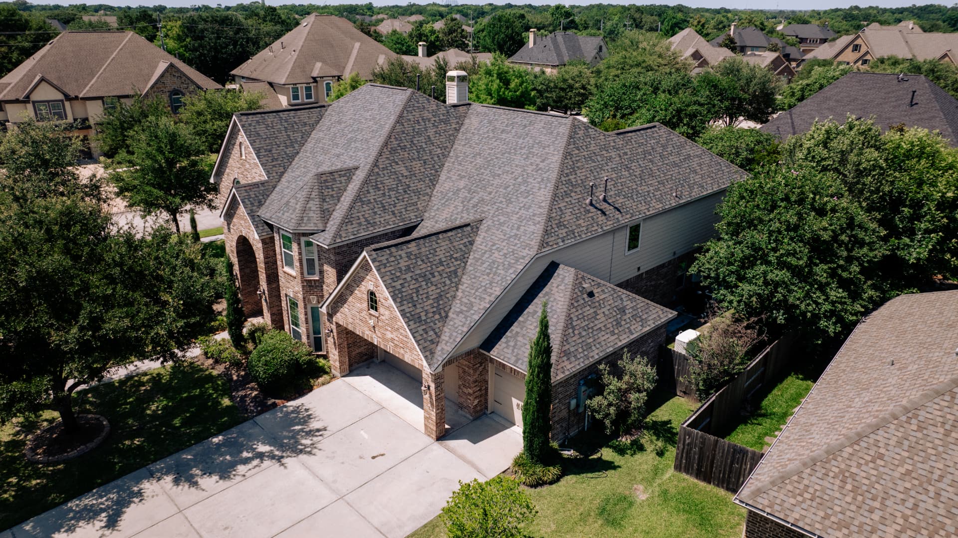 New architectural asphalt shingle roof on a two-story Houston home